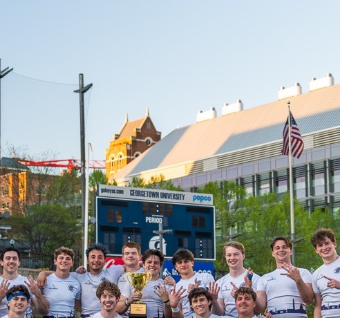 Georgetown rugby team celebrating with a trophy — original photo